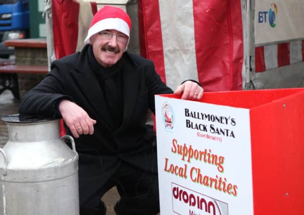 Thursday 20th December.. Ballymoney's Black Santa Liam Beckett on Ballymoney Main Street during his Christmas Sit Out... Pic Steven McAuley/Kevin McAuley Photography Multimedia