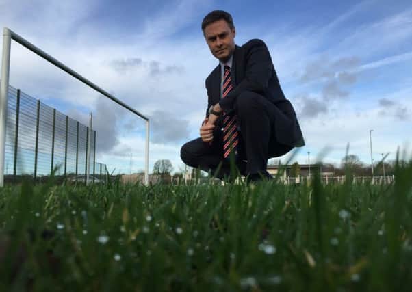 Local MLA Paul Frew takes a first hand look at Clough football pitch. (Submitted Picture).