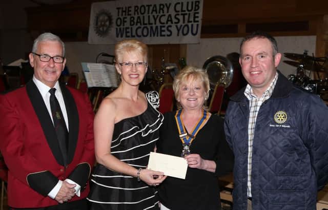 Stanley Alexandra from Britania Band Varlie Haslett accept a cheque from Brenda Caher and Brian Jamison Ballycastle Rotary