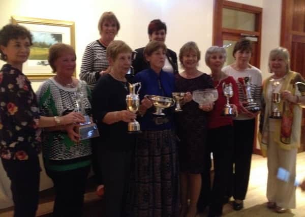 Dunmurry Ladies receive their prizes at the recent presentation.
