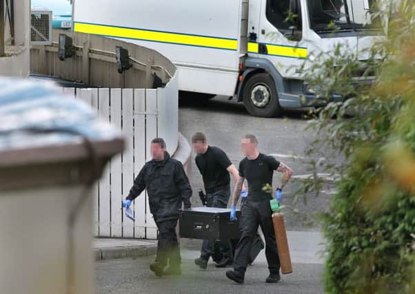 Members of the Army Bomb Disposal team make their way into the Waterfoot Hotel.