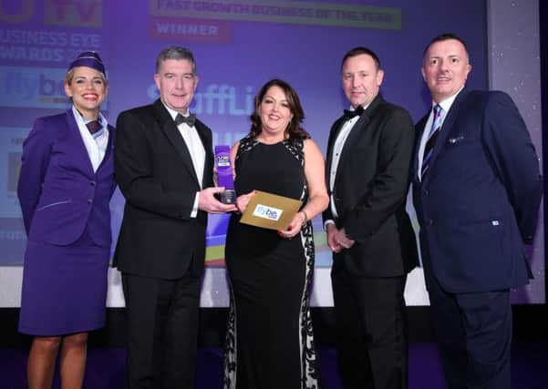 Colin McNab, Operations Director, Charles Hurst presents Tina McKenzie, Managing Director, Staffline Group Ireland and Adrian McCourt, Divisional Director, Staffline OnSite with the Fast Growth Business of the Year Award at the UTV Business Eye Awards, alongside Flybe crew members. INNT 50-509CON Picture by Kelvin Boyes, Press Eye