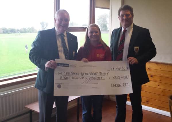 Lynn Cowan from Childrens Heartbeat Trust accepting a cheque of £800 from Larne Rugby Football Club President Phil McMurtry and James McCluggage.  INLT 50-650-CON
