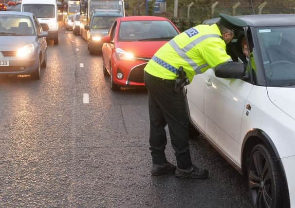 Police hand out leaflets to motorists to launch the winter drink drive operation.