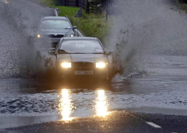 Motorists struggle through floods. Pacemaker