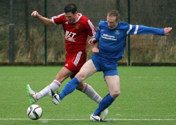 Dollingstown's Glen Hand tries to steal the ball from Annagh United player Philip Craig during last Saturdays match. INPT50-601AM