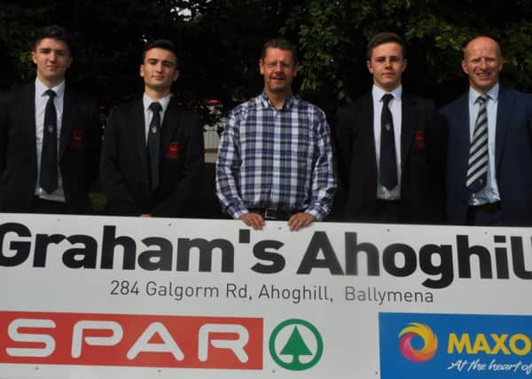 Mr Tom Graham, of Graham's, Ahoghill, presents sponsorship to Ballymena Academy First XV members  Oisin Jordan, Alan Small and Connor Gallagher. Included is the school's marketing co-ordinator Mr Alistair McKay.