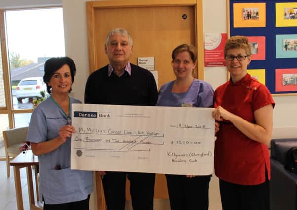 Bertie McWhirter of Killymurris Bowling Club presents Macmillan Cancer Care Unit Antrim with a cheque for £1200.