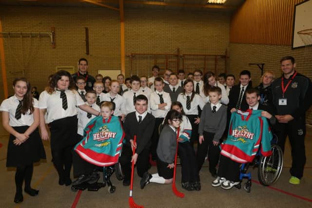 Castle Towers Primary School pupils with Adam Keefe and Mitch Ganzak of the Belfast Giants who visited the school last week. INBT 51-125JC