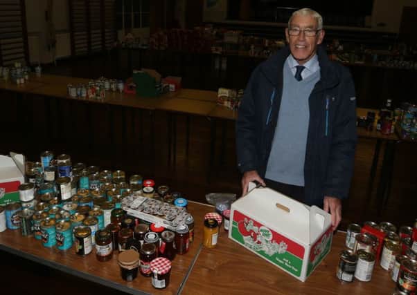 John Stuart of the Ballymena Rotary Club with a selection of food which he and his fellow club members packed into Christmas hampers for delivery to local senior citizens. INBT 51-128JC