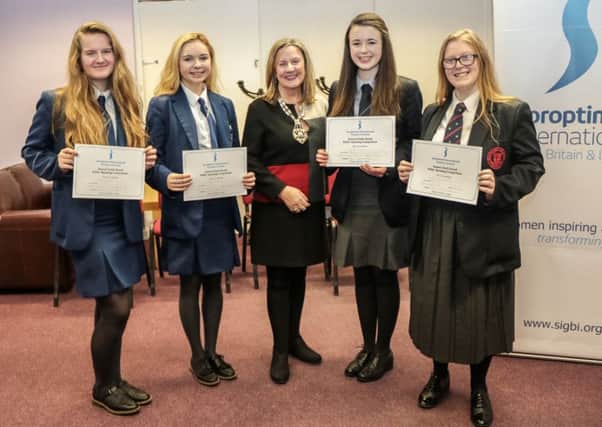 Alice Chapman, President of Soroptimist International of Northern Ireland, with competition winners (l-r) Sarah Logan (Ballyclare Secondary School), Robyn Millar (Ballyclare Secondary School), Natasha McGowan (Larne Grammar) and Jessica Neve Smith (Ballyclare High). INNT 49-501-SO