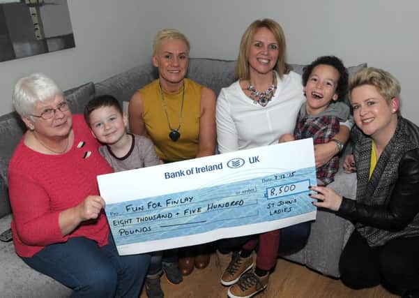 Joan McToal, Kain McWhirter, Vivien Stubbs and Lesley-Ann McWhirter from Larne Masonic Centre present Karen Spiers and her Son Finlay with a cheque for £8,500 to help purchase Finlay a special bike to help him get about better. INLT 49-265-AM