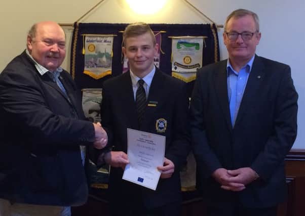 Gracjan Drezewski of St Patrick's College receiving his Youth Leadership certificate from Ballymena Rotary Club president Jim Briggs along with his teacher Willie McKean. (Submitted Picture).