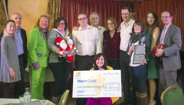 Yvonne Craig from Marie Curie receives cheque for £770 raised at the Songbird Cafe Christmas Show, Ballinderry Inn. Pictured with singers Sophie Giraudeau, Noel Mills, Paul, Alex, Anna and David Murphy, Chrissy Erwin. Joined by friends who supported the charity. Photo by Debbie Deboo.