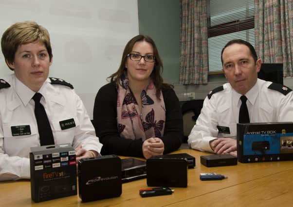 CH. Insp Catherine Magee, Leanne Abernethy Vice Chair PCSP and Supt John Magill Causeway Coast and Glenns District show some of the devices that can be adapted to watch TV illegally. INCR48-15001BW