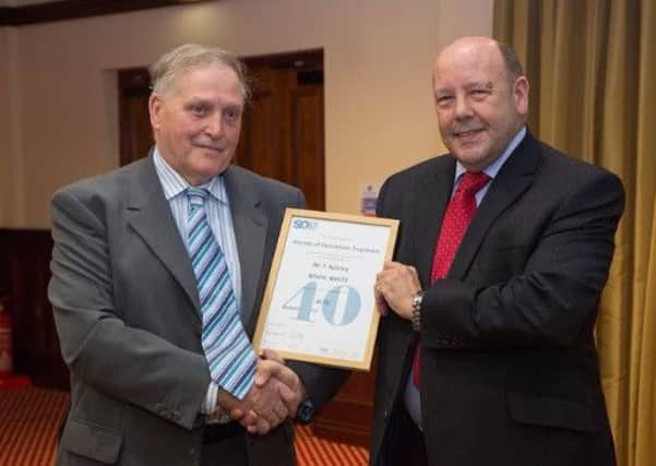 Tom Apsley receives his 40-year certificate from Society of Operations Engineers Immediate Past President, Gerry Fleming.  INLT 51-666-CON