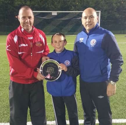 Matthew McCallen picks up his Player of the Month award from Michael O'Kane of the firmus energy Mid-Ulster Youth League and Mark Wilson, Manager of Banbridge Rangers U13s.