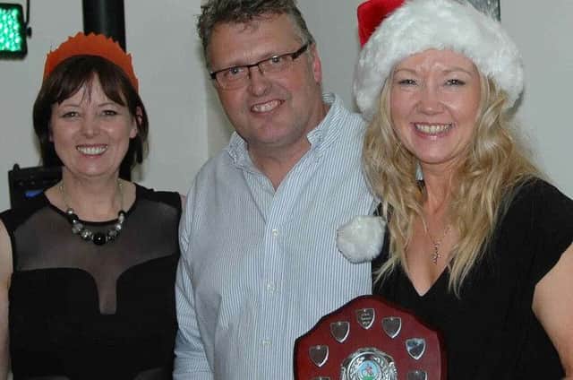 Shonagh Tommasini, Dave Fisher and Andrea Cunningham, showing off her Most Improved Rider award.