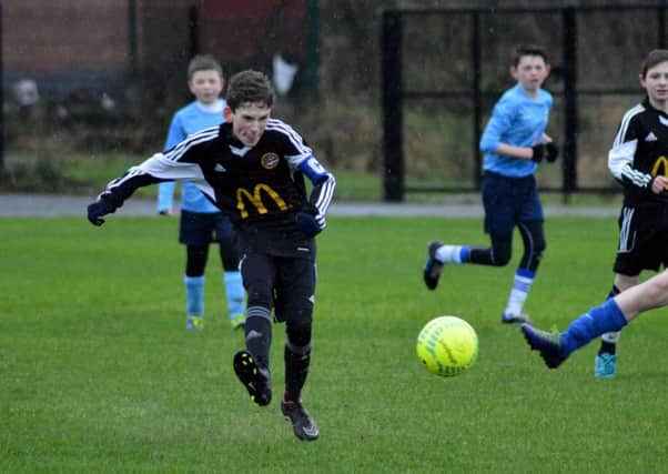 Carniny Youth U13 Captain clears the ball in their NIBFA Cup game with Magherafelt Sky Blues on Saturday