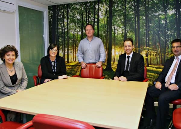 Nigel Wilson showing his visitors one of the conference rooms at the River House Business Centre in Coleraine and seated are Tracy Hegarty of the Alchemy Project, Annette Deighan Operations Manager with the Causeway Chamber of Commerce, Paul Muir of Diamond Recruitment and Peter McRoberts of Danske Bank.   13  Riverhouse