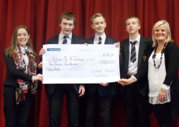 Sarah Duff, schools officer with Action MS, receives a cheque for £3,380 from Larne High School students. INLT 51-631-CON