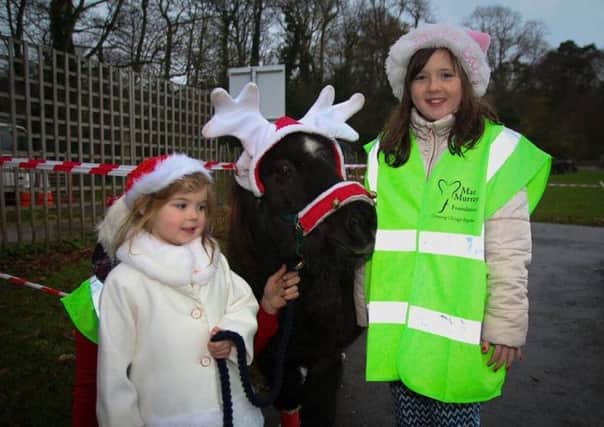 Mia Duddy and Leafi McMaster pictured with Bambi at the 'Team Santa Walk' in aid of the Mae Murray Foundation.  INLT 51-688-CON