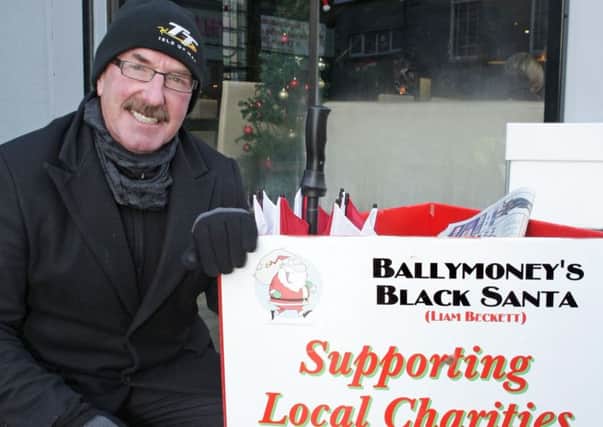 Ex-Institute manager Liam Beckett pictured doing his annual 'Black Santa' Christmas 'Sit Out' for local charities.