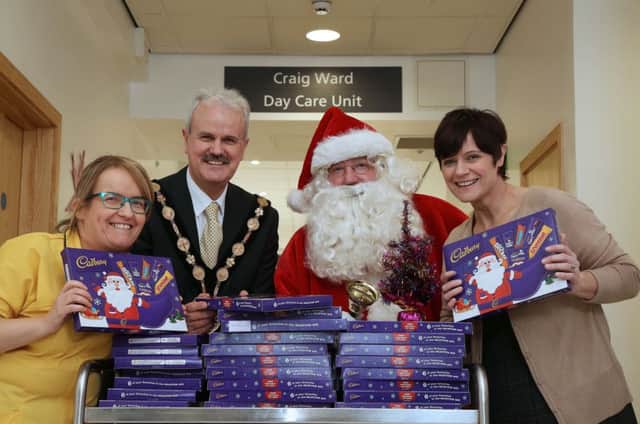 Councillor Thomas Beckett, Mayor of Lisburn & Castlereagh City Council, and Santa Claus visited the Ulster Hospital, Dundonald, recently to wish children in hospital a very Happy Christmas. Pictured are Sharon Millar, Hospital Play Specialist and Teresa Mungur, Clinical Manager, Paediatrics.