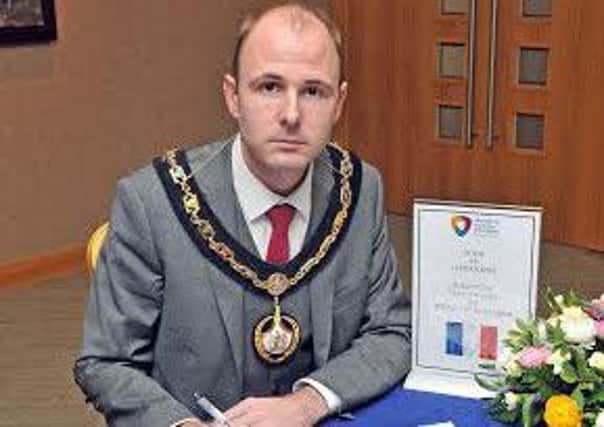 Lord Mayor of Armagh City, Banbridge and Craigavon Borough Council, Councillor Darryn Causby opens the book of condolence at Craigavon Civic Centre.