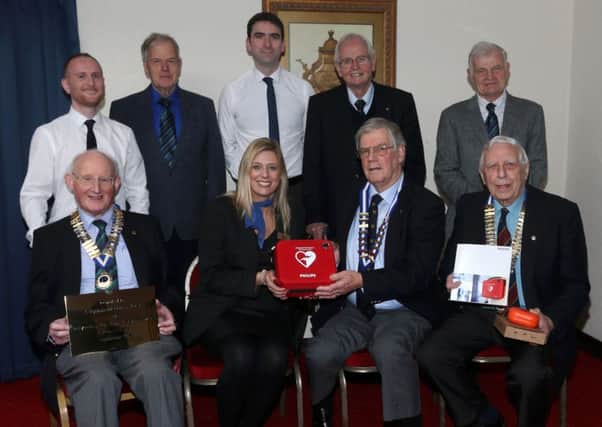 Representatives of the three local Probus Clubs present a Defibrillator to the Leighinmohr House Hotel Sales Manager Nikki Armstrong. They are: L-R, President of Pentagon Probus James Erwin,  President of Seven Towers Probus Ken Atkinson and President of Ballymena Probus Club,  Herbie Park. Also pictured is (back left) Darren McGinty of Ballymena Borough Council who trains volunteers in defirillator use, Adrian Fullerton of Leighinmohr Hotel and other representatives of the three Probus Clubs.. INBT 52-107JC