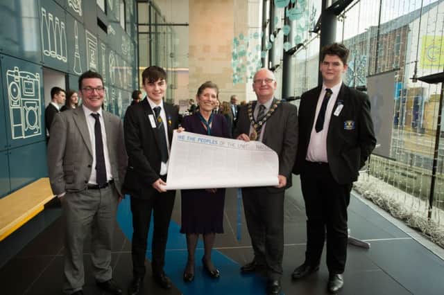 Matthew Braiden and Joel Hannah with Mr McCready, from Carrickfergus College, receiving a copy of the United Nations Charter from the Mayor of Mid and East Antrim Borough, Councillor Billy Ashe  and a representative for the UN Association Northern Ireland. INCT 51-709-CON