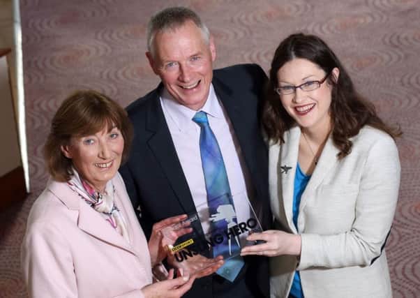Dr John Hinds' mother, Josephine, his partner Janet Atcheson and fellow Flying Doctor, Fred MacSorley, collected the Unsung Hero Award on his behalf.