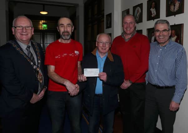 Pius McKeran of Ballymena Road Club presents a cheque for £900 (proceeds of the entry donations from the club's Fun Tour series) to John Duffin of the Ballymena support group of the Chernobyl Childrens Appeal. Included is Mayor of Mid & East Antrim Cllr Billy Ashe, Ballymena Road Club chairman Paul Murdoch and outgoing committee member Richard Wilson. INBT 51-172CS