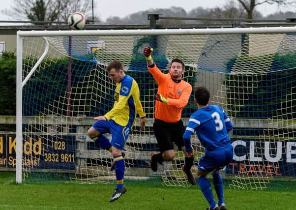Dollingstown keeper Kris Fletcher punches clear against Bangor.