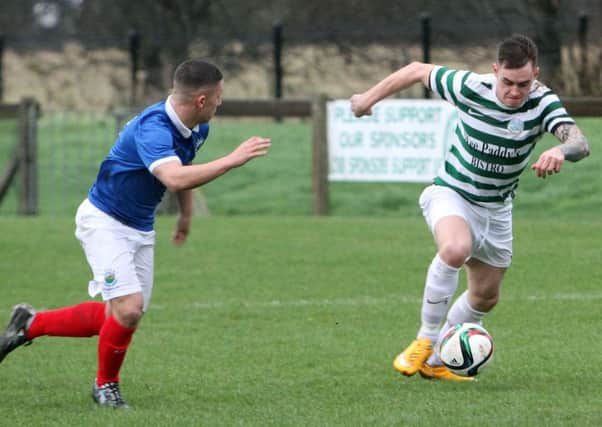 Lurgan Celtic player Chris Lavery keeps his head down as he tries to sprint past his Linfield Swifts opponent. INLM52-610AM