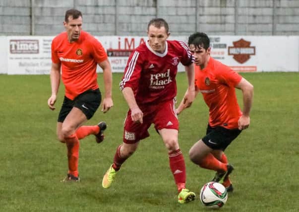 Ballyclare's JB Dobbin escapes the attentions of Carrick Rangers Reserves opponents. INNT 51-543-SO