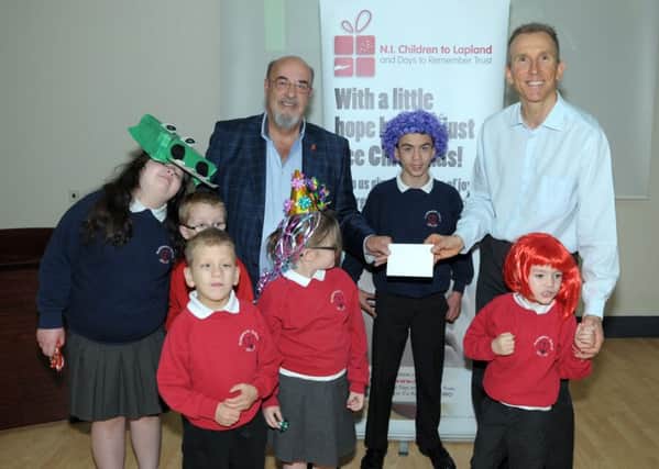 Jack Rodgers MBE, Chairman NI Children to Lapland and Days to Remember Trust accepts a £200 cheque from Roddensvale School Principal Mr Madden and pupils (archive pic). INLT 21-231-AM