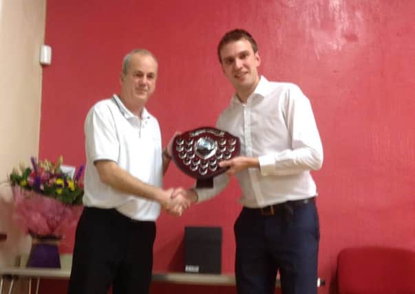 Paul Canning (left), winner of the Duneane singles bowling tournament, receives his prize from tournament organiser Alex Bell.