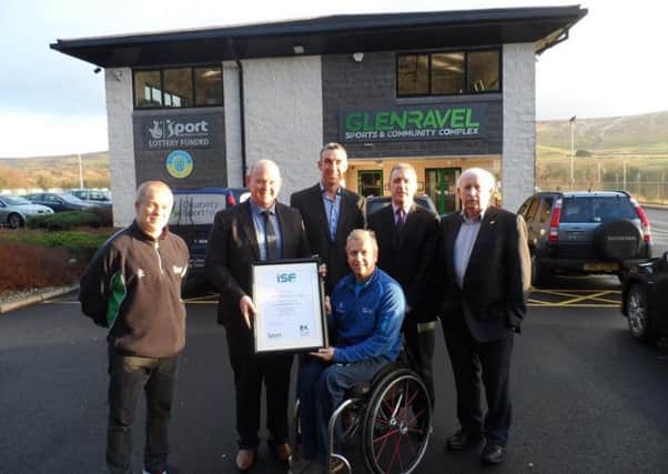 Members of Glenravel Sports & Community Complex receive the Inclusive Sports Facility Accreditation award from Aubrey Bingham, of Disability Sport NI.