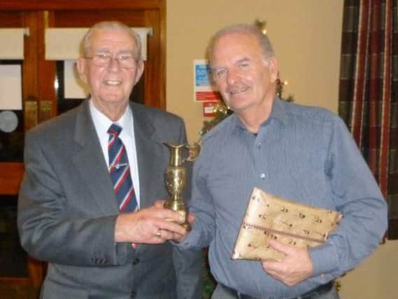 Harry McMeekin presents the John Smyth Memorial Trophy to Bobby Geddis.