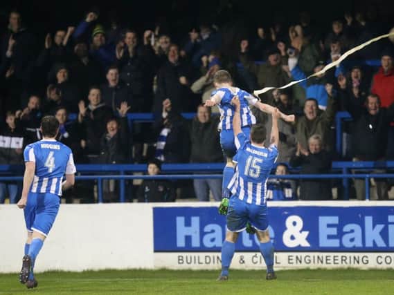 Coleraine's Jamie McGonigle is lifted high by team mate James McLaughlin after scoring his team's match winning goal