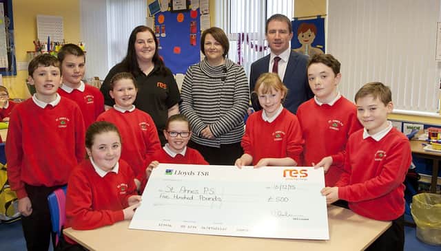 Victoria Graham presenting 500 to the staff and pupils of St Anne's Primary School Corkey, included are School Principal Mr Henry Duffin and Chairperson of the Board of Governors, Mrs Claire Kelly.