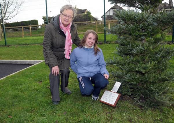 Irene and Louise Crawford unveil a plaque in memory of Husband and Father, Edwin,who was a large part of Island life. INLT 51-243-AM