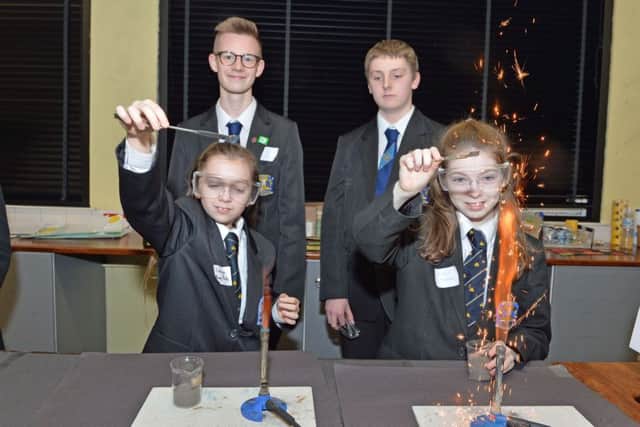 Lauryn Hill and Kate Neill carry out an experiment while Noah Barnley and Philip Lindsay look on at Carrickfergus College open night. INCT 02-001-PSB