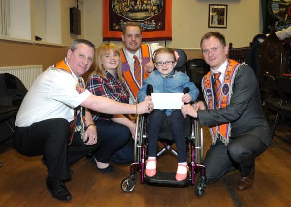 Woodburn Ebenezer LOL No 787 Worshipful Master, Aaron Peoples and Worshipful Deputy Master, Darren McAllister present little Sophie Mathers with a Â£3,700 cheque raised by the lodge.  Also pictured are Sophie's mum and dad, John and Jane. INCT 02-213-AM