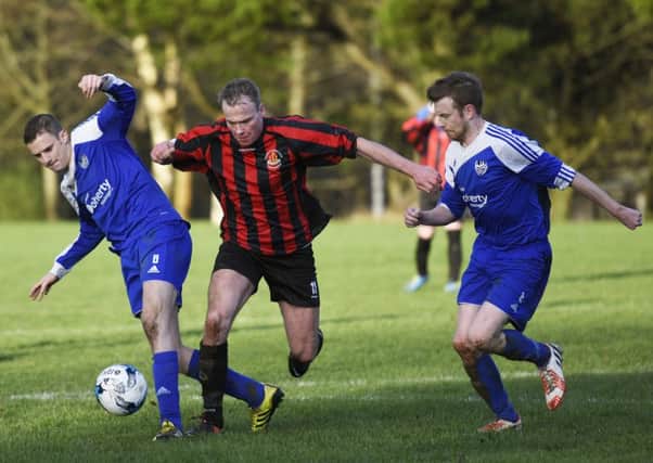 BBOB's Liam Doherty battles for the ball in midfield during Saturday's Irish Junior Cup match aginst Strule United. INLS0216-118KM