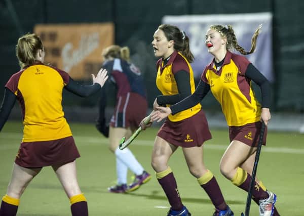 Mossley's Amy Jones and Lauren McKee celebrate with Sophie McDowell (right) who scored all four goals in the 4-0 win over Owls on Friday evening. INLT 02-906-CON Photo: Philip McCloy