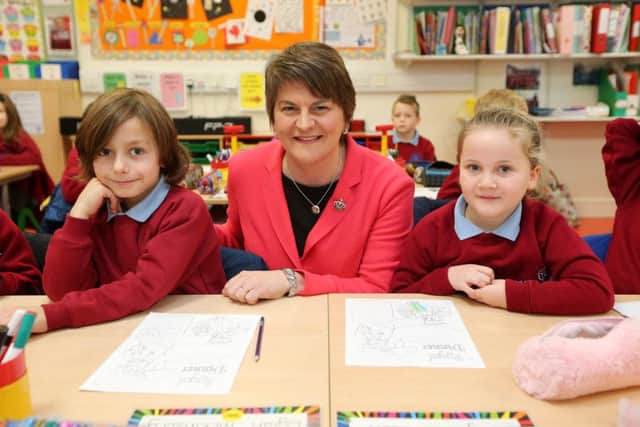 Press Eye - Belfast - Northern Ireland - 12th January 2016 - 

New First Minister Arlene Foster visits Pond Park Primary School in Lisburn on her first engagement. 
She is pictured with meeting pupils from Primary 3 Dylan  McKinstry and Casey Richardson during the tour of the school.

Picture by Kelvin Boyes / Press Eye.