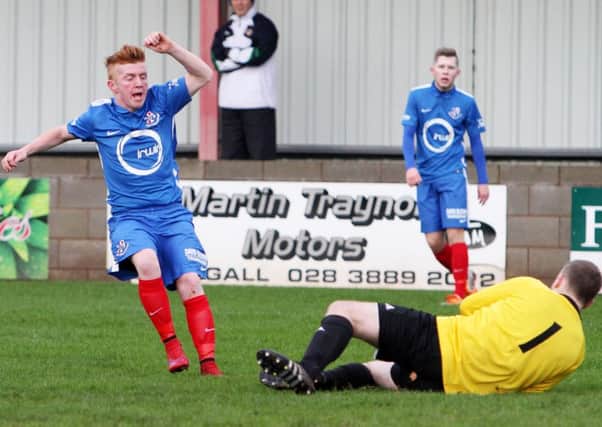 Stuart Mallen is stopped from a spot on the scoresheet by Larne goalkeeper Paddy Flood but the Loughgall full-back came out on top overall at Lakeview Park.INPT02-668AM