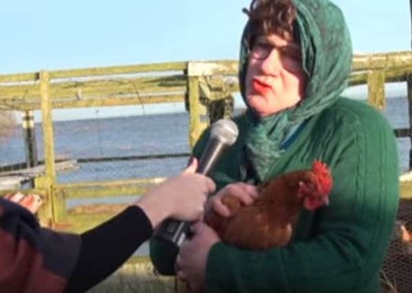 Mrs Flood is interviewed with one of her hens